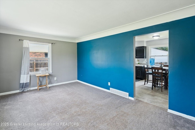 3427 W Jolly Rd, Lansing, MI 48911 - spare room featuring carpet and baseboards