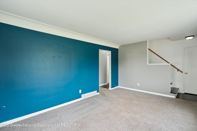 3427 W Jolly Rd, Lansing, MI 48911 - spare room featuring stairs and carpet floors