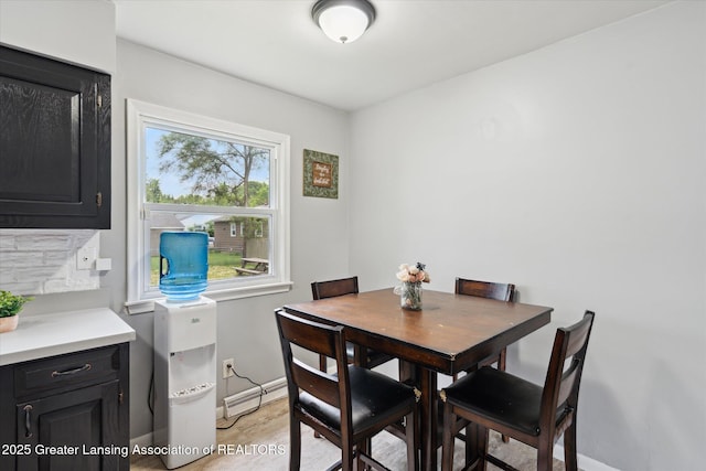 3427 W Jolly Rd, Lansing, MI 48911 - dining space featuring baseboards and a baseboard heating unit