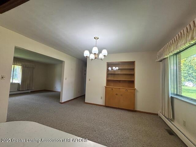 505 S Baker St, Saint Johns, MI 48879 - unfurnished dining area with a baseboard radiator, carpet flooring, a chandelier, and baseboards