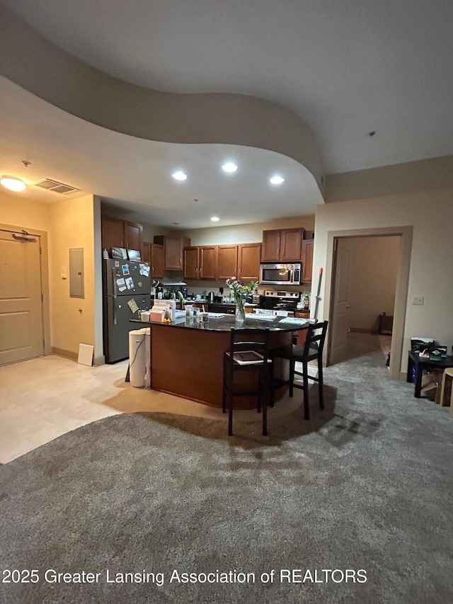 living room featuring light carpet, visible vents, electric panel, and recessed lighting