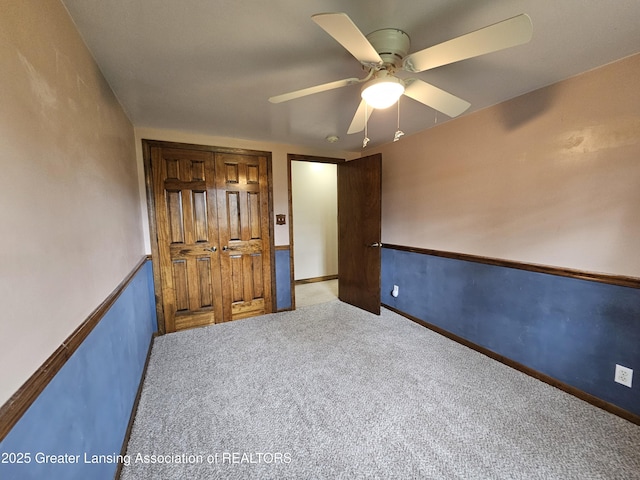 unfurnished bedroom featuring carpet flooring and ceiling fan