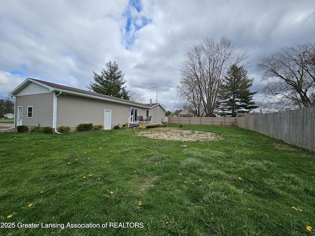 view of yard featuring a deck and fence