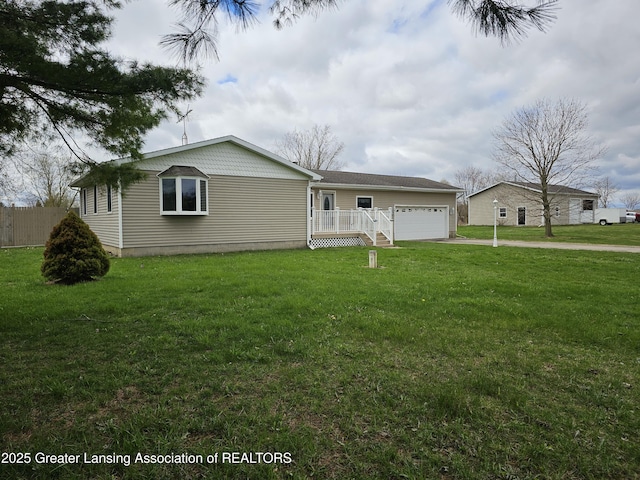 ranch-style house with a garage, fence, and a front yard