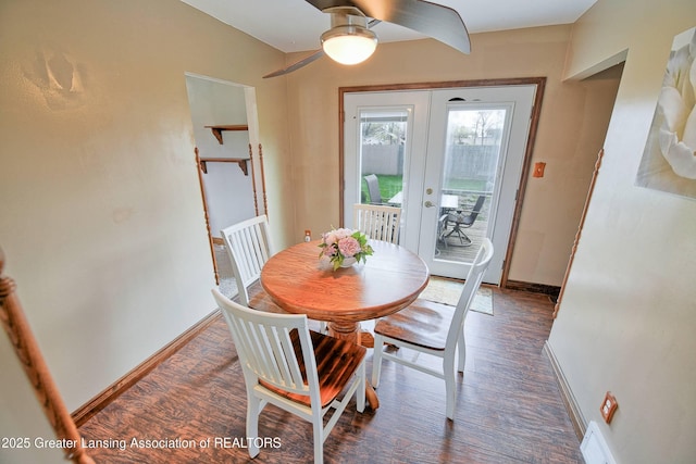 dining space featuring baseboards, wood finished floors, a ceiling fan, and french doors