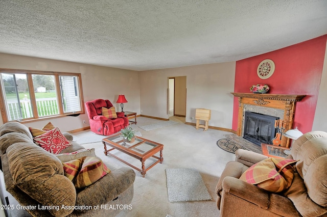 living area with a high end fireplace, a textured ceiling, carpet, and baseboards
