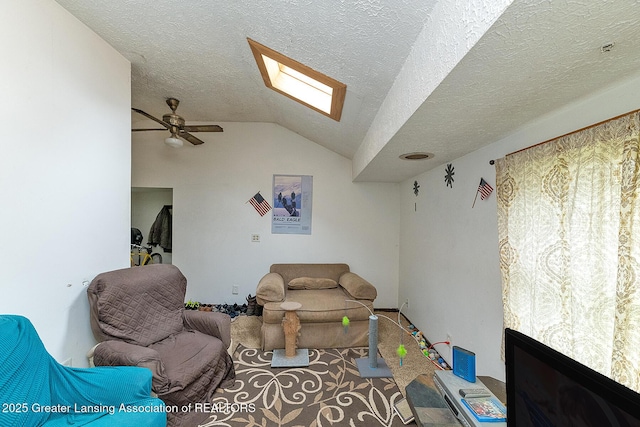 carpeted living room featuring a skylight, lofted ceiling, a ceiling fan, and a textured ceiling