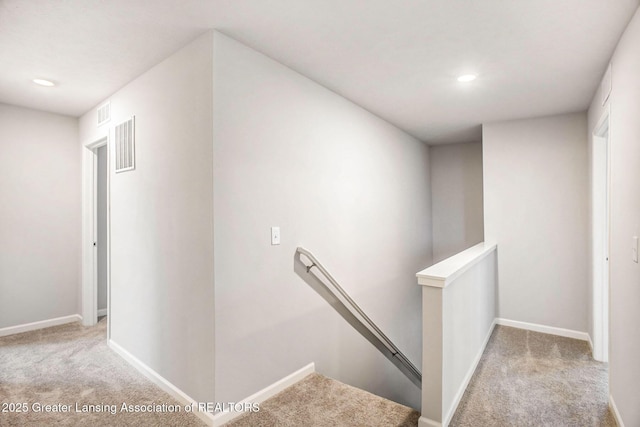 4493 Sunset Dr, Potterville, MI 48876 - hall featuring visible vents, baseboards, carpet flooring, and an upstairs landing