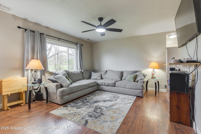 living area featuring a ceiling fan, wood finished floors, and visible vents