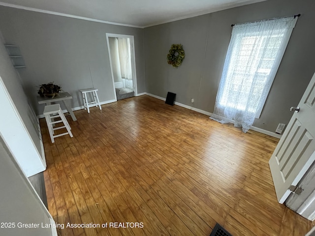 325 N Pennsylvania Ave, Lansing, MI 48912 - spare room featuring hardwood / wood-style flooring, crown molding, and baseboards