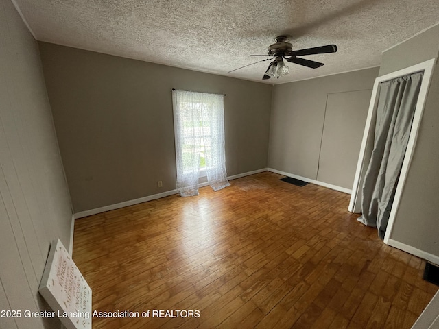 325 N Pennsylvania Ave, Lansing, MI 48912 - empty room with ceiling fan, wood finished floors, a textured ceiling, and baseboards