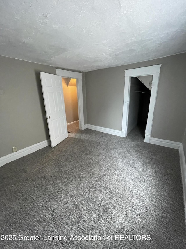 325 N Pennsylvania Ave, Lansing, MI 48912 - unfurnished bedroom with a textured ceiling, carpet flooring, and baseboards