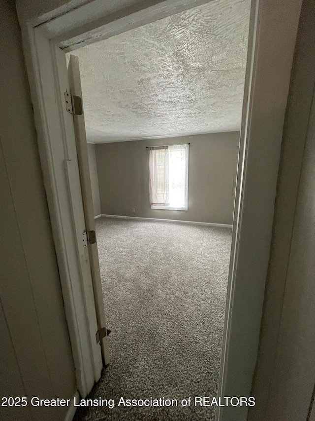 325 N Pennsylvania Ave, Lansing, MI 48912 - carpeted spare room with a textured ceiling and baseboards
