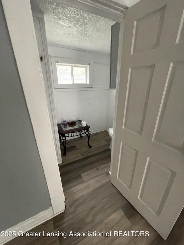 325 N Pennsylvania Ave, Lansing, MI 48912 - hall with wood finished floors, baseboards, and a textured ceiling