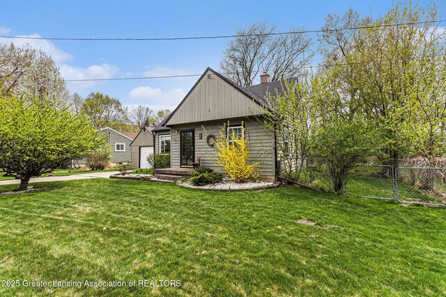 bungalow featuring a front lawn, a garage, a gate, a chimney, and fence