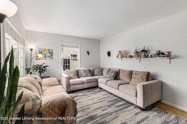 living area featuring wood finished floors and baseboards