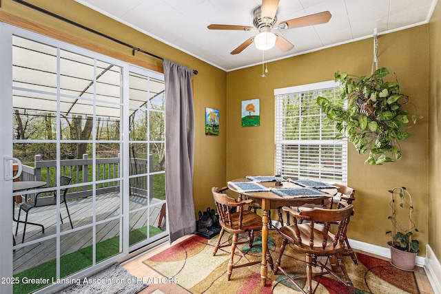 dining space featuring ceiling fan, wood finished floors, and baseboards