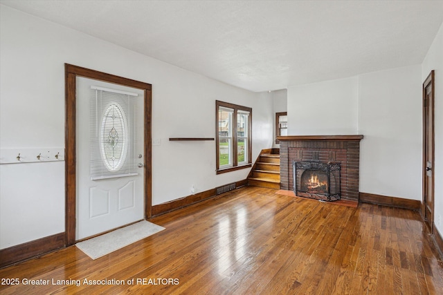interior space with visible vents, baseboards, plenty of natural light, and hardwood / wood-style floors