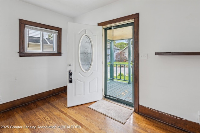 foyer featuring baseboards and wood finished floors