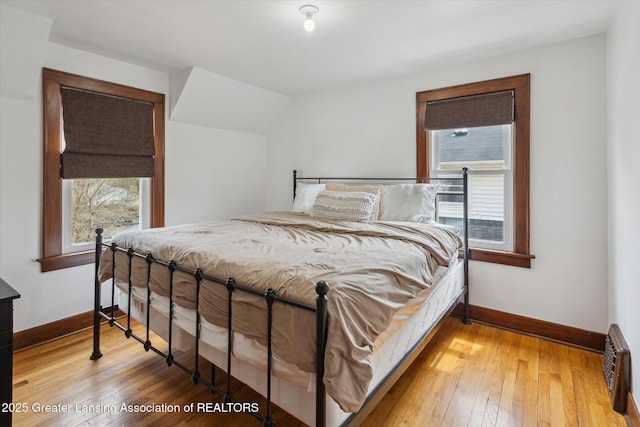 bedroom featuring wood-type flooring and baseboards