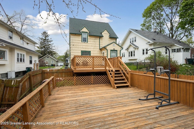 deck with a fenced backyard, a residential view, and central AC unit