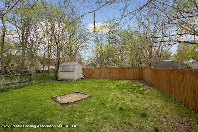 view of yard featuring an outdoor structure, a fenced backyard, and a shed