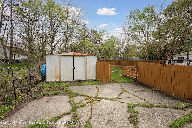 view of shed with fence private yard and a gate