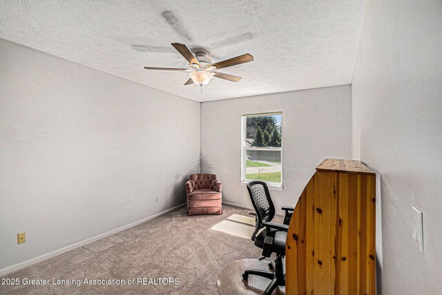 office area featuring baseboards, ceiling fan, carpet floors, and a textured ceiling