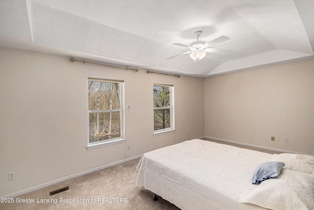 carpeted bedroom with baseboards, visible vents, ceiling fan, and lofted ceiling