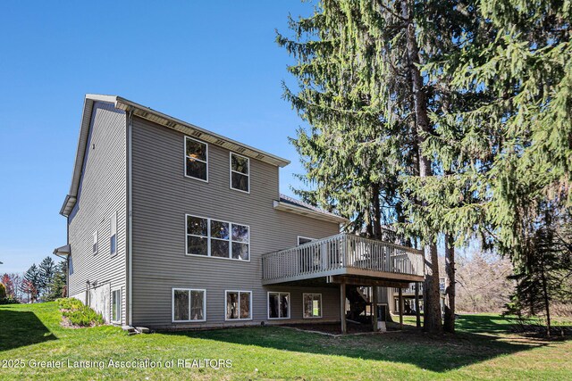 back of house with a deck and a yard
