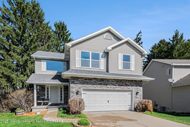 view of front of home featuring driveway, stone siding, a shingled roof, an attached garage, and a porch