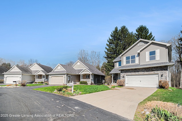 craftsman house featuring concrete driveway, a garage, and a front yard