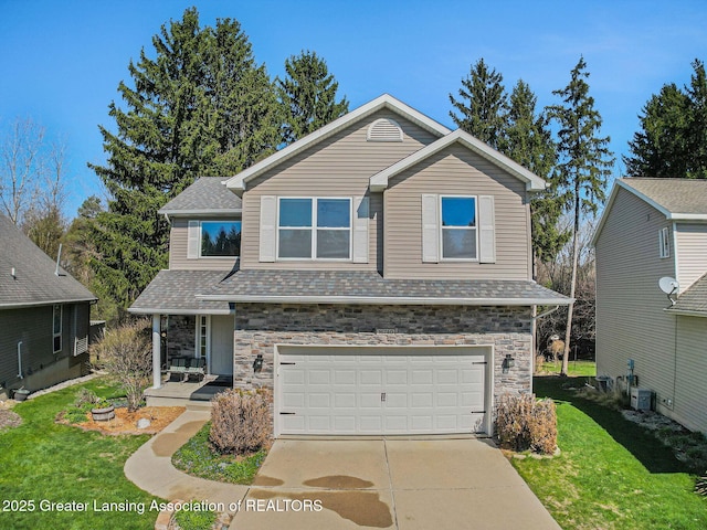 view of front of home featuring a front lawn, stone siding, and a garage