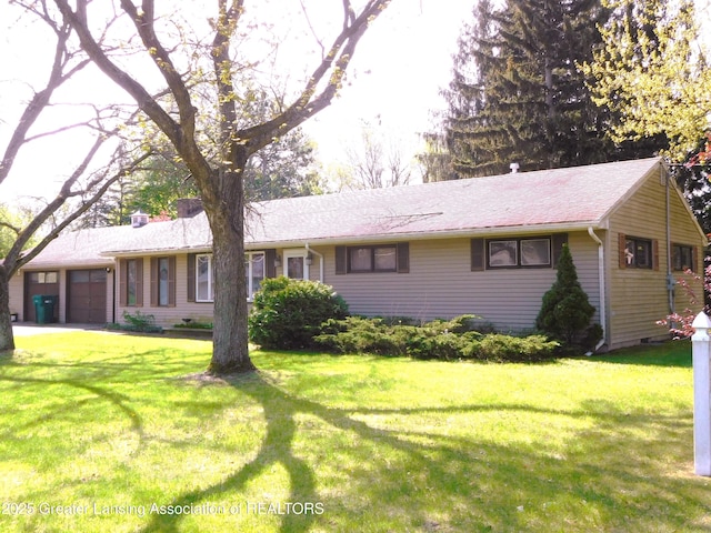 ranch-style house featuring an attached garage, crawl space, and a front yard