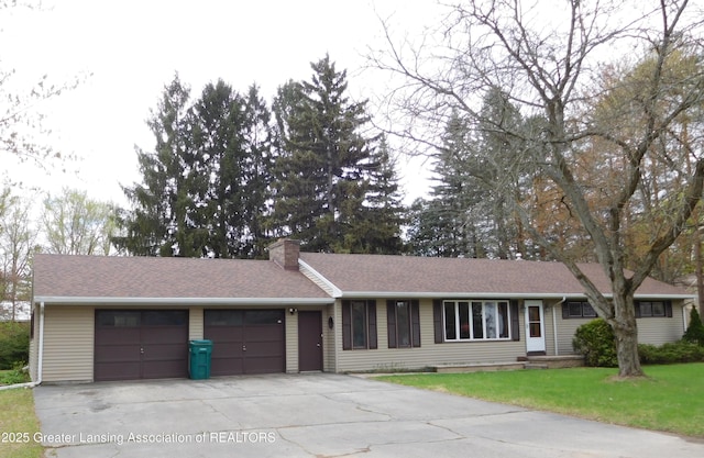ranch-style house with concrete driveway, a chimney, roof with shingles, an attached garage, and a front lawn