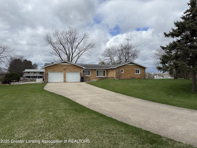 single story home featuring brick siding, a front yard, driveway, and an attached garage