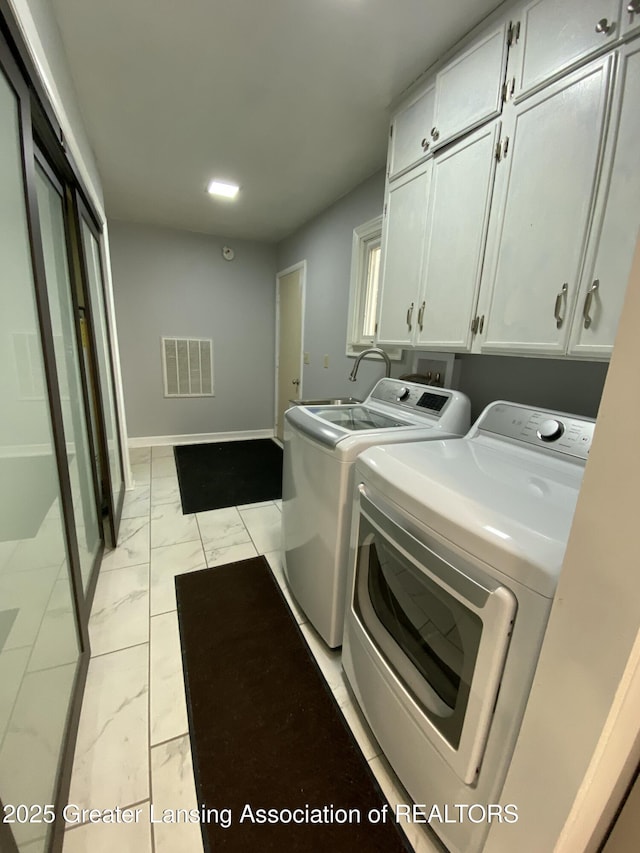 laundry room with washing machine and dryer, visible vents, baseboards, cabinet space, and marble finish floor