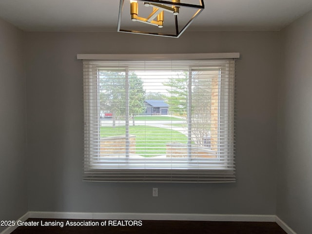 interior space with baseboards and a notable chandelier