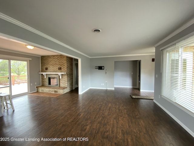 unfurnished living room with a fireplace, dark wood-style flooring, ornamental molding, and baseboards