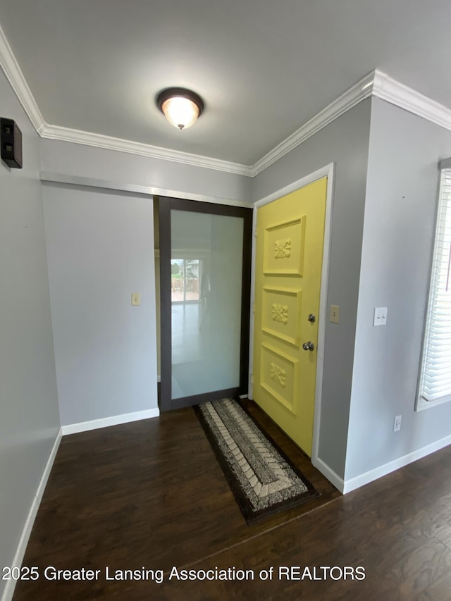 doorway to outside with baseboards, wood finished floors, and crown molding