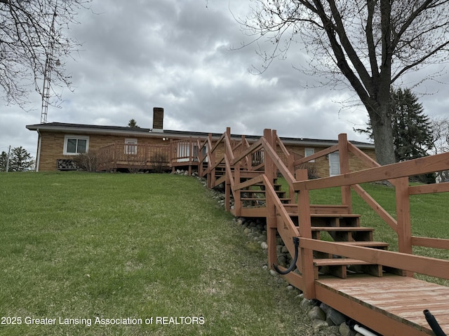 view of yard with a deck and stairs