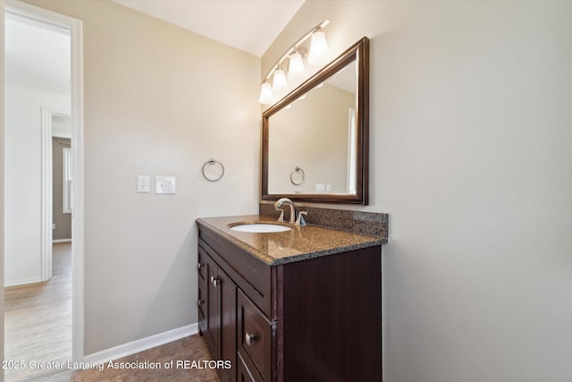 bathroom featuring vanity and baseboards