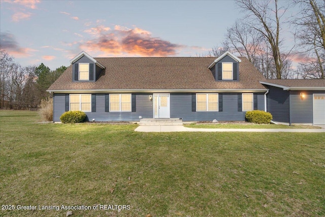 cape cod-style house with a shingled roof and a front lawn
