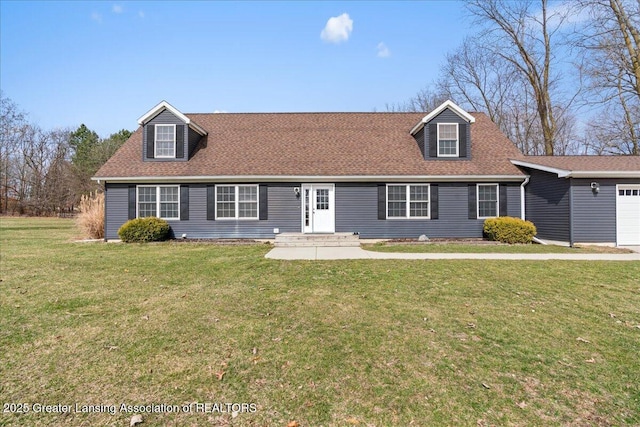 new england style home with an attached garage, a front lawn, and roof with shingles