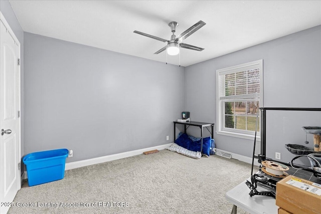 interior space featuring ceiling fan, carpet floors, visible vents, and baseboards