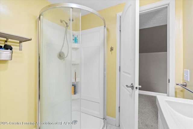 full bath featuring baseboards and a shower stall
