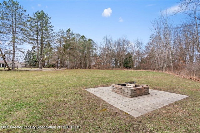 view of yard featuring a fire pit and a patio