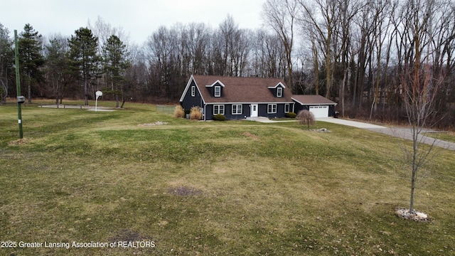 view of front of house featuring an attached garage, a front lawn, and driveway