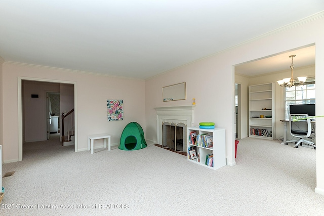 carpeted living room with a brick fireplace, baseboards, an inviting chandelier, and ornamental molding