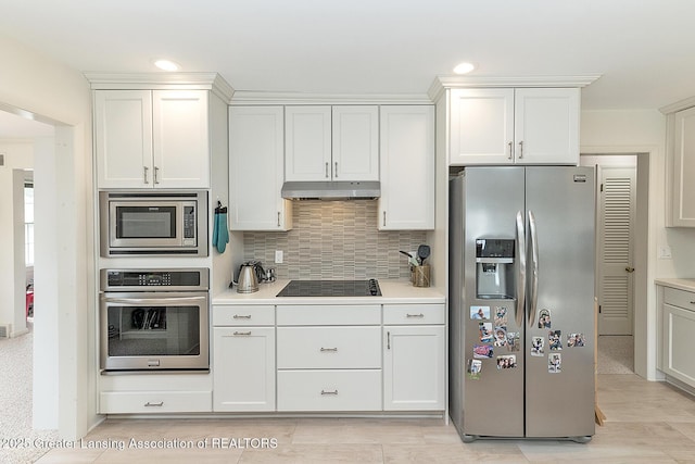 kitchen featuring light countertops, appliances with stainless steel finishes, under cabinet range hood, and tasteful backsplash